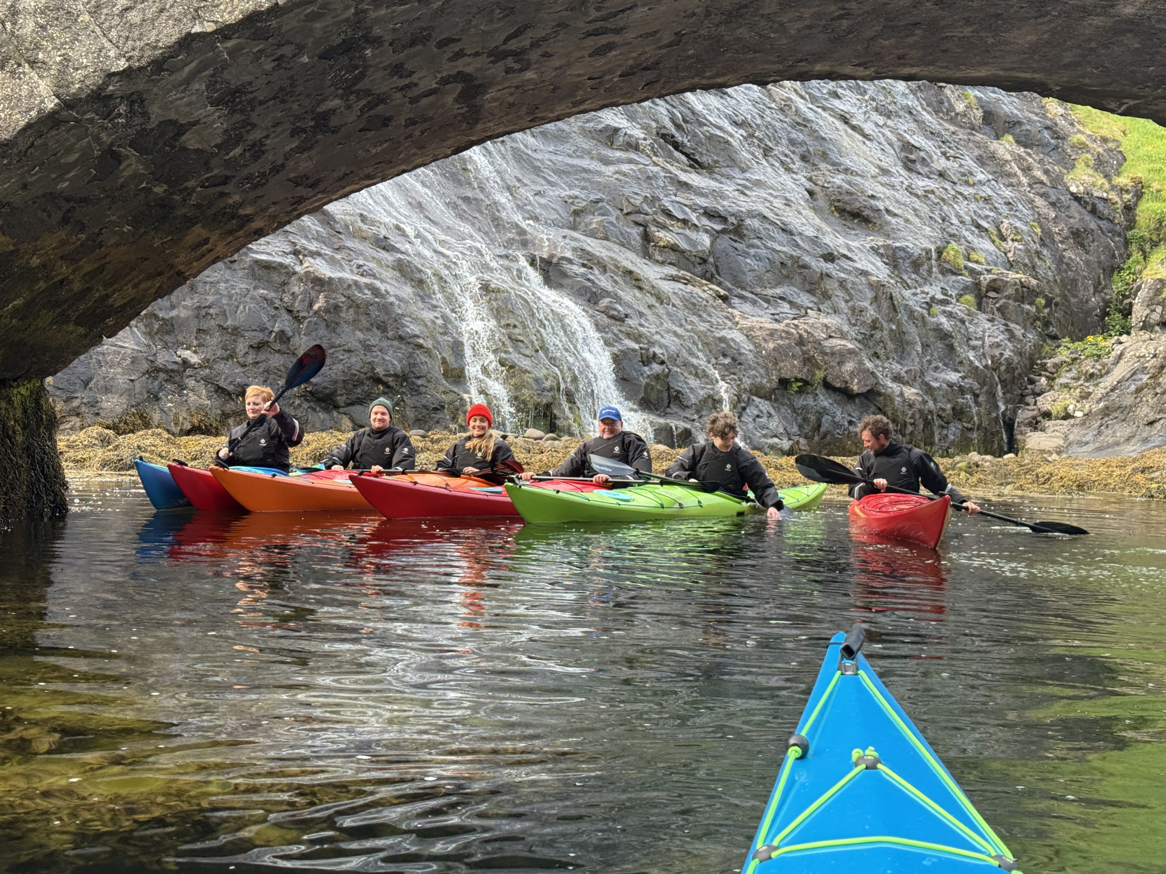 Kayaking under rock arch
